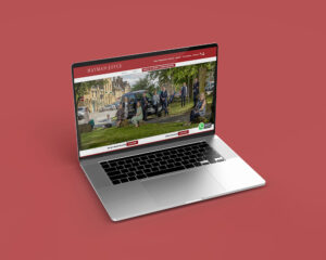 A red background with a Macbook in front displaying a website home page